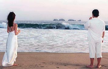 Newlyweds watching a sunset from El Manantial
