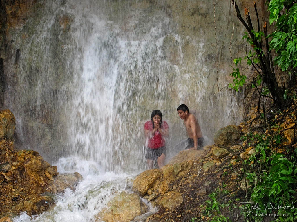 Young couple in waterfall, Ixtapa