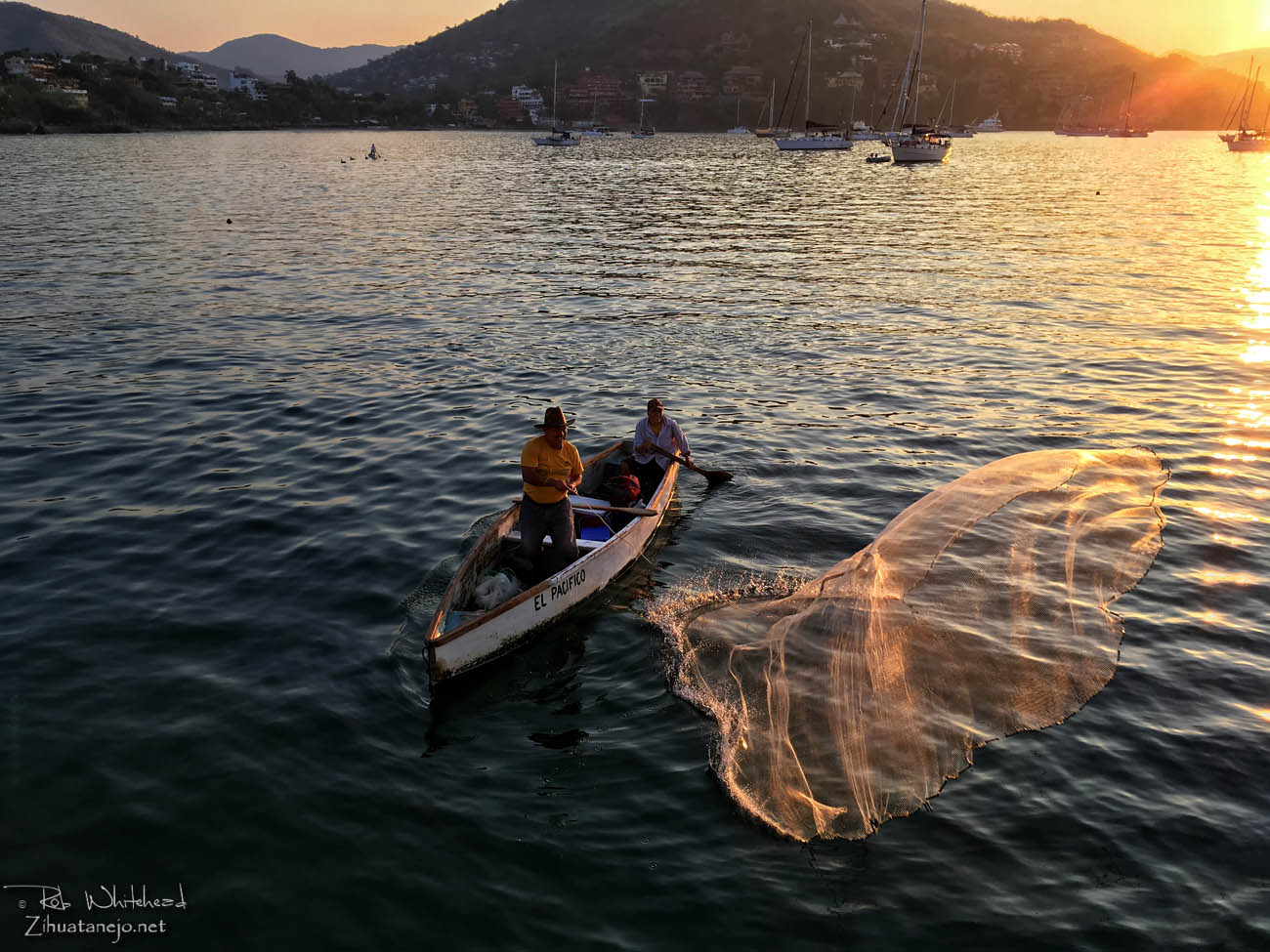 Fisherman casts net from canoe, Zihuatanejo